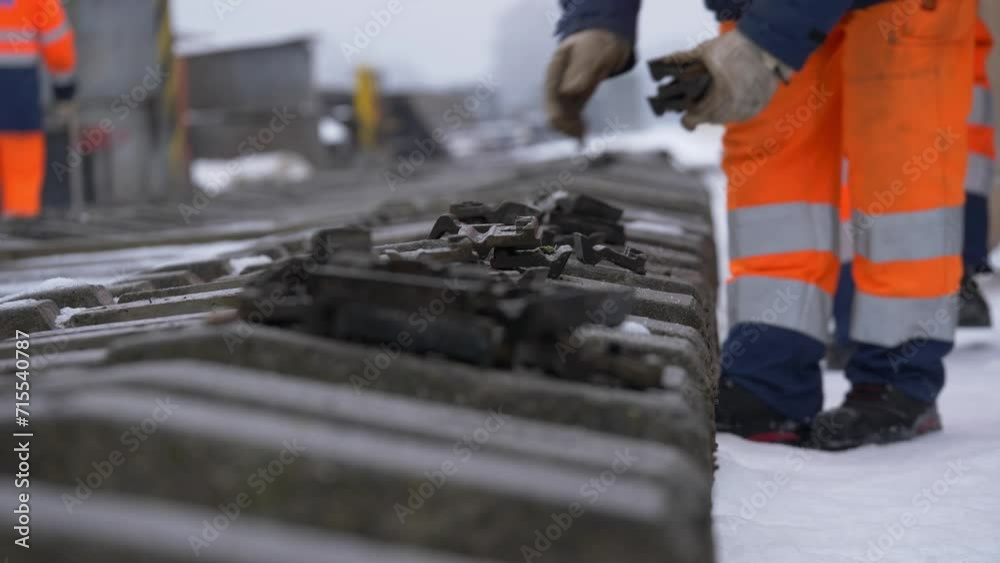 Workers are repairing snow-covered railway tracks. Unrecognizable people. Workers are repairing snow-covered railway tracks. Unrecognizable people.