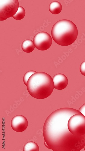 Abstract assorted shiny red color beads or pearls falling slowly over red color background. 