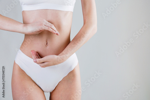 Cropped shot of woman touching making a circle shape over the stomach. Gut health concept. Close up  copy space  background.