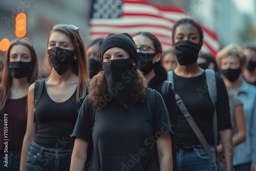 Group of women wearing black masks participated at a rally on city street. © FutureStock