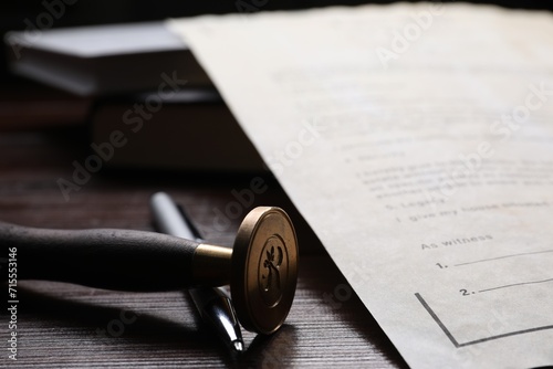 Last Will and Testament, stamp seal and pen on wooden table, closeup photo