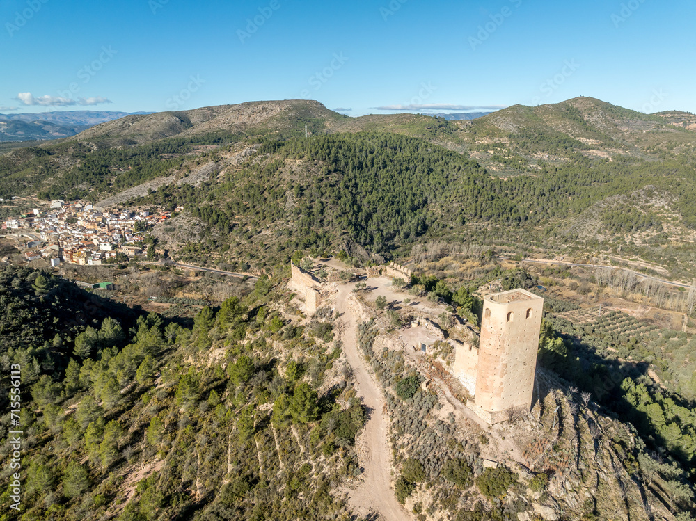 Aerial view of Almonecir Castle,  in the Sierra de Espadán above Vall de Almonacid, irrigated farmlands and an extensive olive groves with horseshoe shaped great tower partially restored
