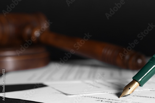 Writing on documents with fountain pen at table, closeup and space for text. Notary contract