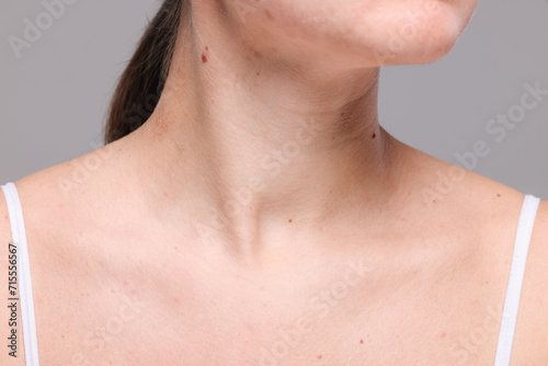 Closeup view of woman with normal skin on grey background