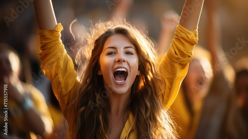 group of fans dressed in yellow color watching a sports event in the stands of a stadium