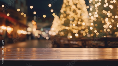 An empty wooden tabletop with a warm, bokeh light background of a festive Christmas market, ideal for product display.