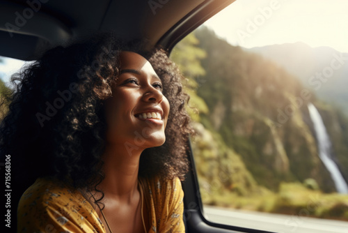 Tablou canvas A black women rides in a car and enjoys views of mountains and waterfalls