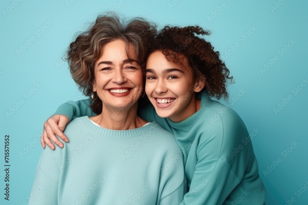 An elderly woman and a young girl. Mom and daughter are smiling. An elderly woman and a young girl. Mom and daughter are smiling.