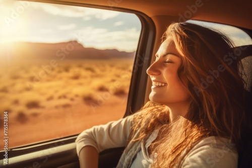 A woman rides in a car and enjoys the views of the desert. Auto travel. Car trip. © P
