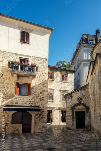 Fototapeta Naklejka Na Ścianę i Meble -  Morning walk along winding narrow streets with ancient stone buildings in the old town of Kotor, Montenegro