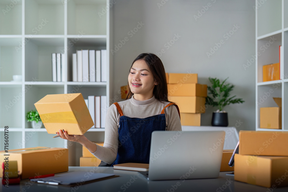 Woman use scotch tape to attach parcel box to prepare goods for the process of packaging, shipping, online sale internet marketing ecommerce concept startup business idea Woman use scotch tape to attach parcel box to prepare goods for the process of packaging, shipping, online sale internet marketing ecommerce concept startup business idea