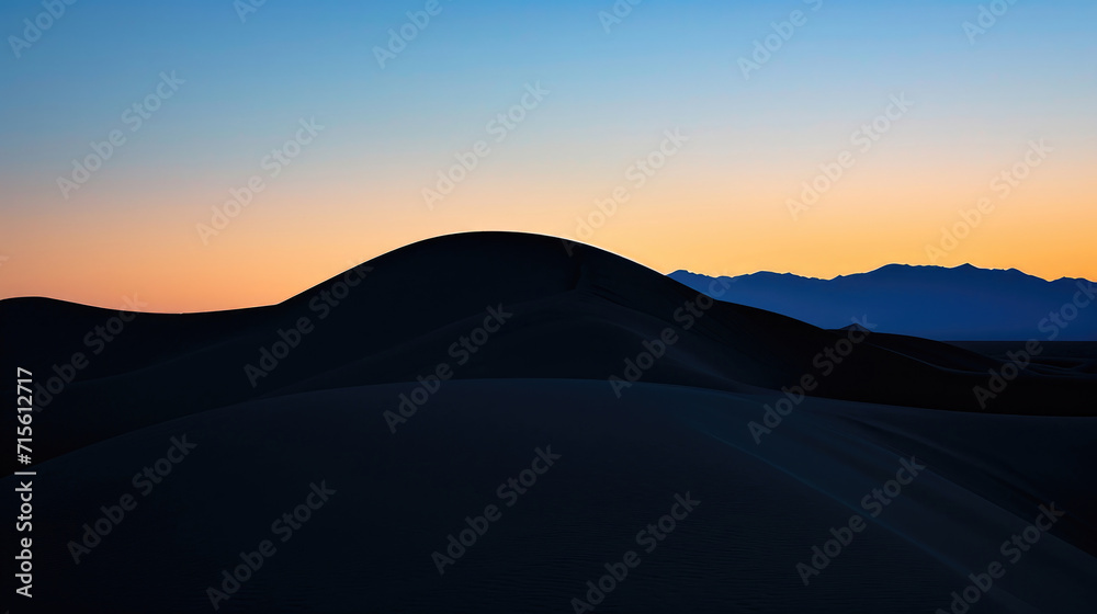 The majestic form of desert dunes against the twilight sky