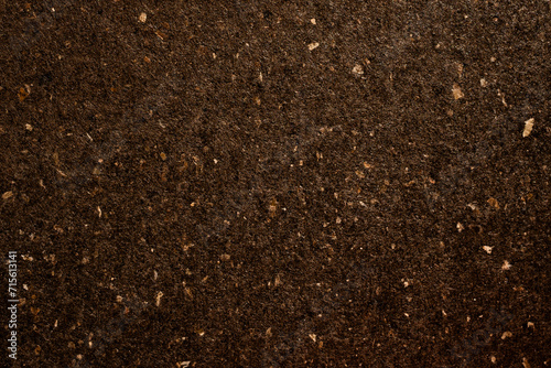 Macro detail of dark brown colored artisan paper texture with natural fibres