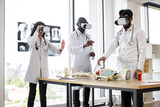 Human anatomy, VR, education, medicine concept. Young multiracial researchers using virtual reality goggles while working with human skeleton. Team of scientists in modern laboratory