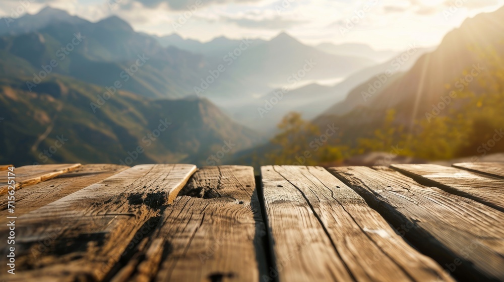 Empty wooden table top product display showcase stage. Blurred mountains in the background, with peaks reaching to the sky. - obrazy, fototapety, plakaty 