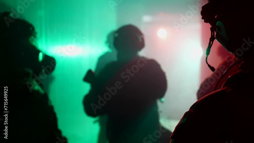 counterterrorist tactical unit working in building seized by terrorists, silhouettes of soldiers photo