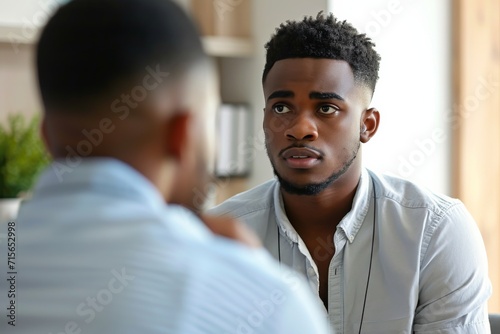 Supportive Psychologist Empathetically Listens To A Troubled Young Black Mans Concerns Standard. Сoncept Mindfulness Meditation For Stress Relief, Self-Care Practices For Mental Health photo