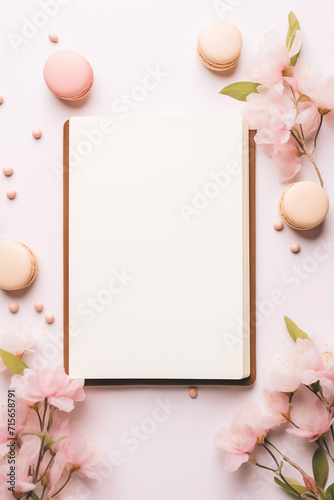 Pastry style border design with an open recipe book placed in the center with blank pages to place text. Natural, fresh and baked desserts with copy space and light background.
