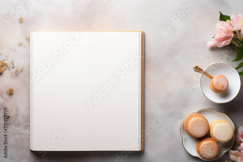 Pastry style border design with an open recipe book placed in the center with blank pages to place text. Natural, fresh and baked desserts with copy space and light background.