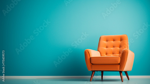 Modern orange armchair on blue wall background © Antonio