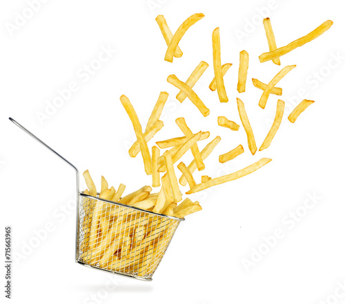 French fries flying out of falling stainless steel fryer basket isolated on white background.