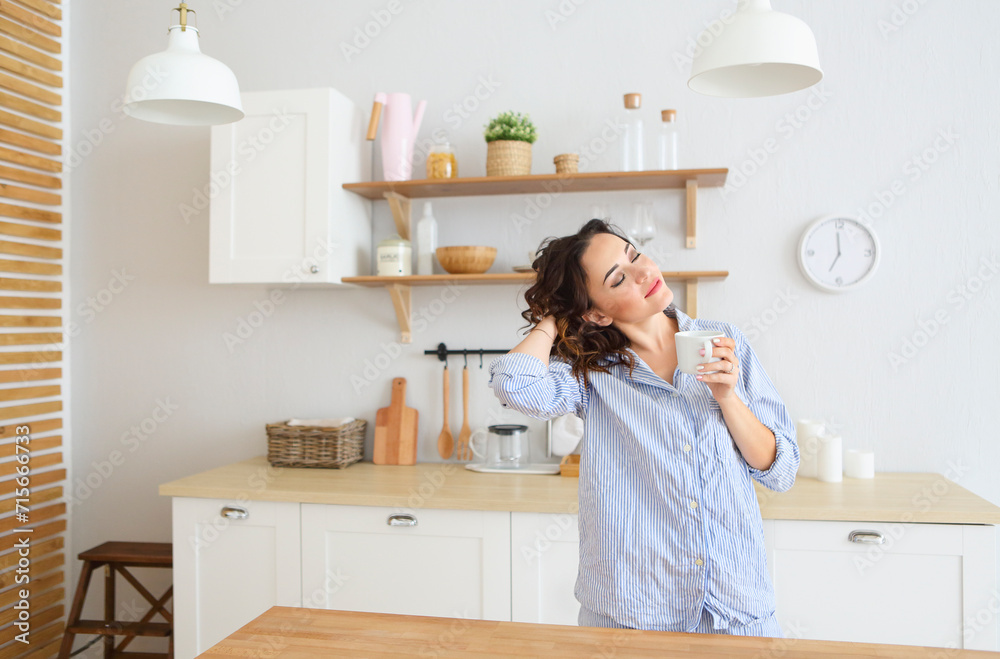 Young pretty woman drinking her morning coffee at kitchen Young pretty woman drinking her morning coffee at kitchen