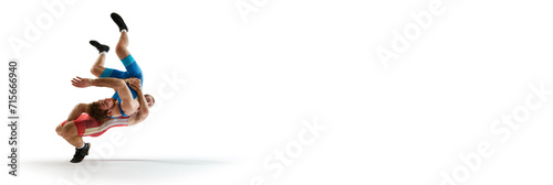 Banner. Athlete men, skilled wrestlers in red and blue uniform fighting in motion against white studio background with negative space to insert text. Concept of sport, mixed martial arts, match. photo