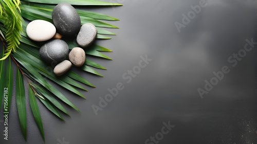 Gray background with spa stones Pastel color background for product photography with stones and tropical leaves  