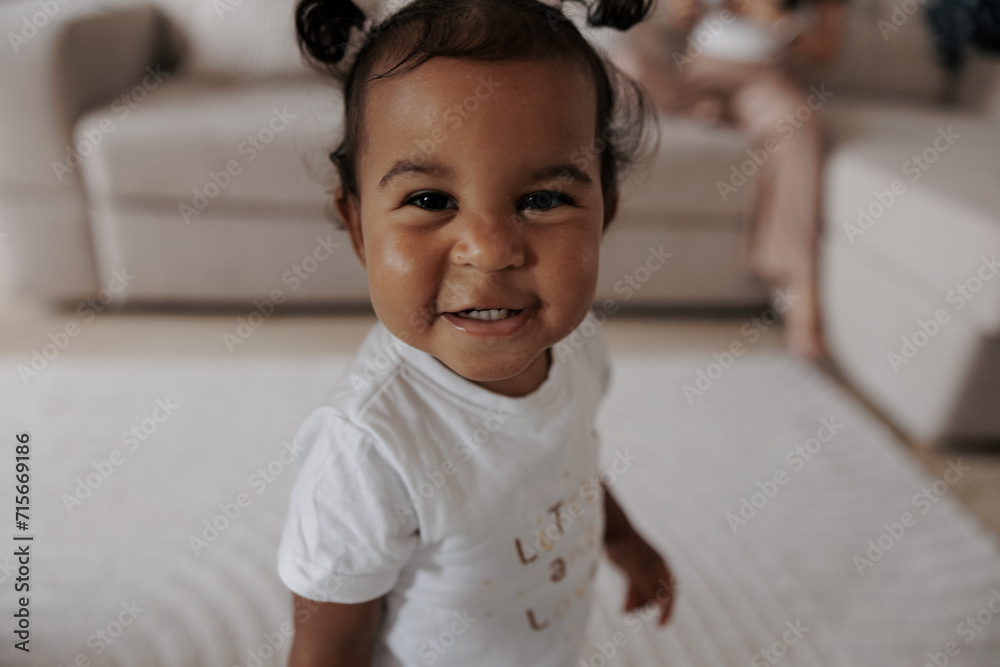 Portrait of joyful mixed race toddler girl in room. Portrait of joyful mixed race toddler girl in room.