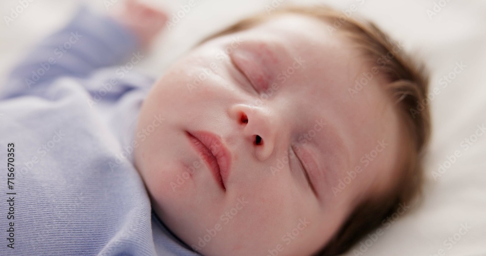 Face, growth and sleep with a baby on a bed closeup in a home, dreaming during a nap for child development. Relax, calm and rest with an adorable newborn infant asleep in a bedroom for comfort Face, growth and sleep with a baby on a bed closeup in a home, dreaming during a nap for child development. Relax, calm and rest with an adorable newborn infant asleep in a bedroom for comfort