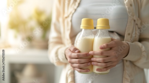 mother holds a baby milk bottle, moment of care baby and beauty with elements of health and milk in a close-up composition