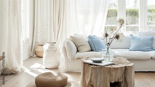 Interior Design Mockup: A coastal living room with soft blue and sand hues, relaxed linen upholstery, driftwood elements, and sheer white curtains