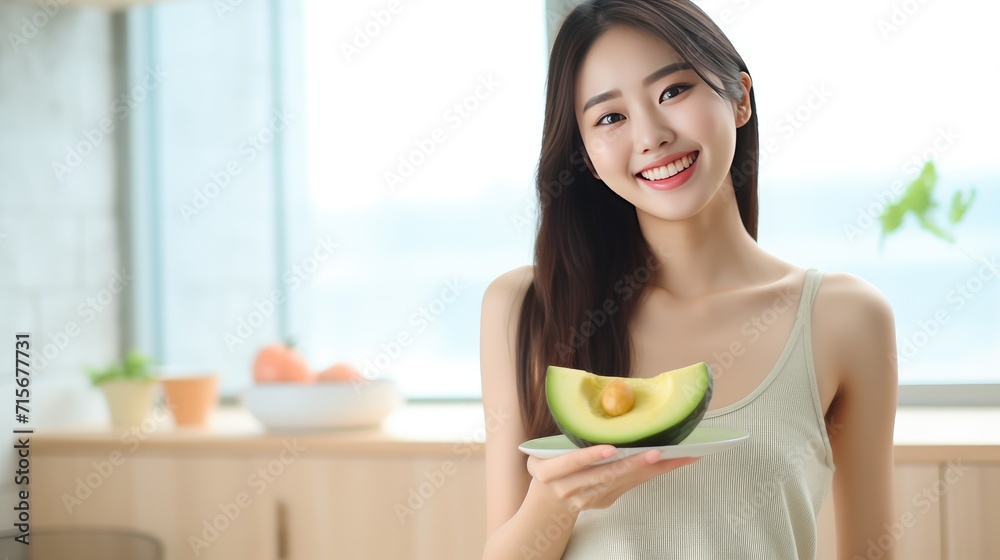 Beautiful teenage girl eating Avocado healthy food diet concept, personalized nutrition food plant of fresh vegetable salad meal, top view photo with space for texts Beautiful teenage girl eating Avocado healthy food diet concept, personalized nutrition food plant of fresh vegetable salad meal, top view photo with space for texts