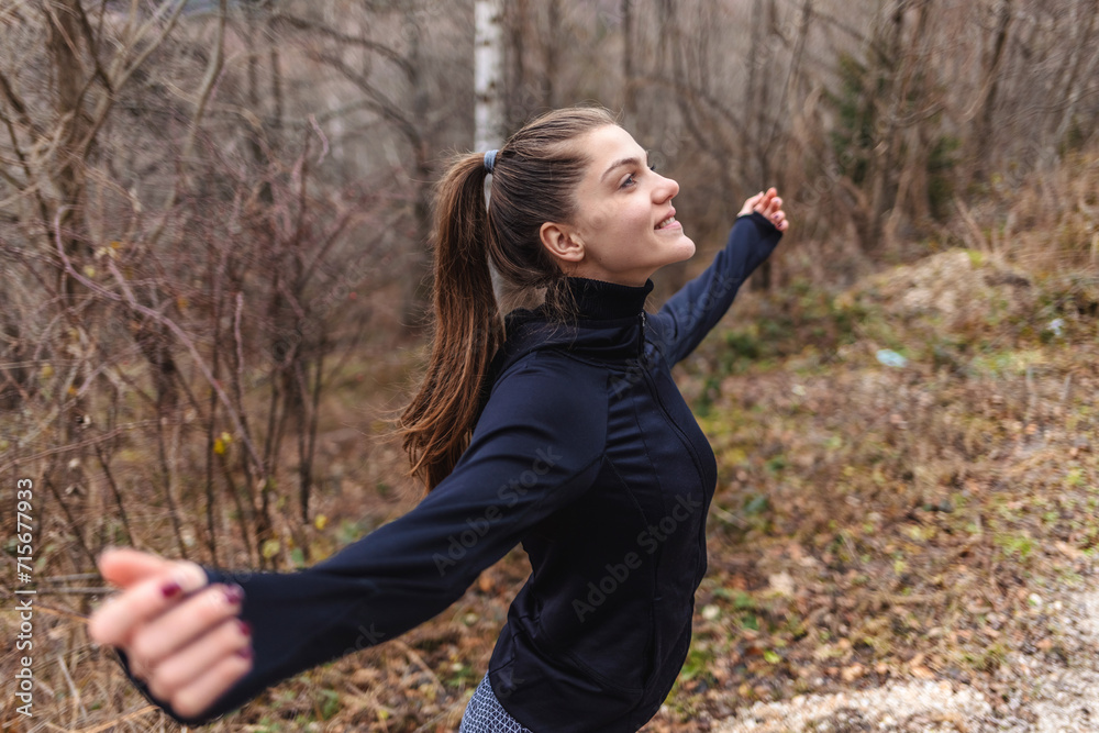 Freedom, fitness and woman in nature spreading hands wide open. Open arms, peace and female relax outdoors on break enjoying view after running, exercise or training, hike or workout. Freedom, fitness and woman in nature spreading hands wide open. Open arms, peace and female relax outdoors on break enjoying view after running, exercise or training, hike or workout.