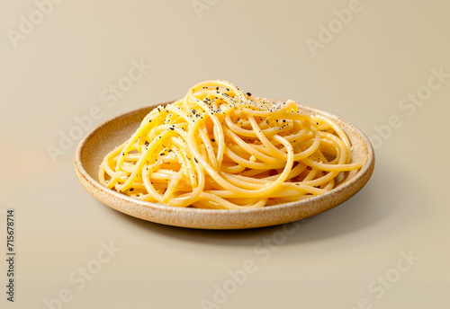 Caci e pepe spaghetti on a plate isolated on a beige background photo