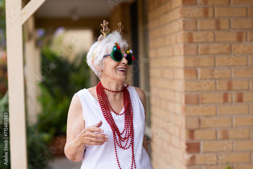 fun-loving octogenarian having fun dressed up fancy for Christmas
