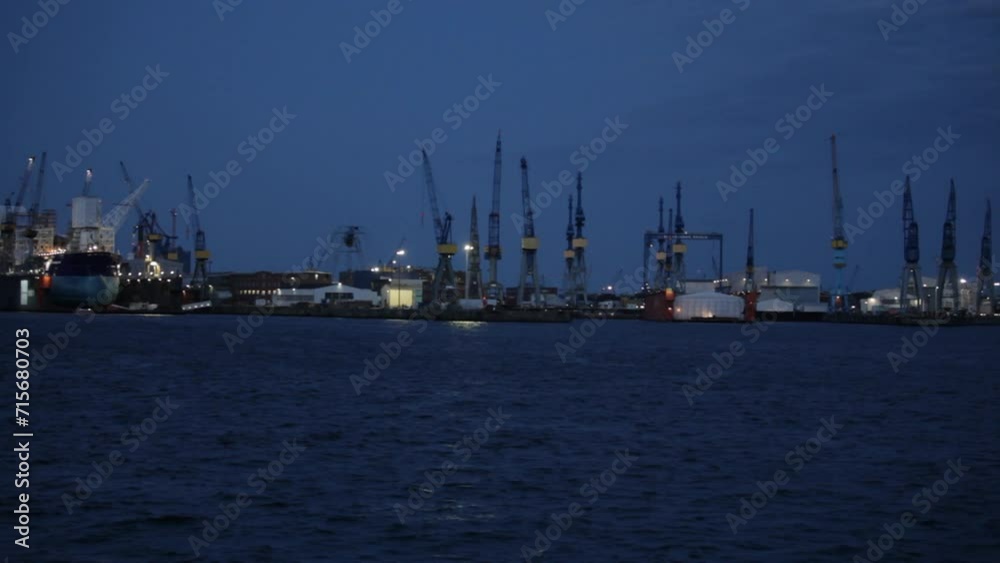 Container ships and cranes at dusk, Port of Hamburg, Germany Container ships and cranes at dusk, Port of Hamburg, Germany