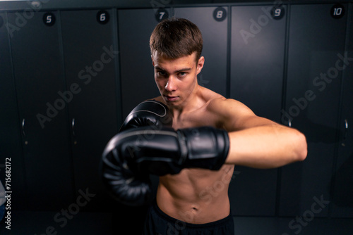 portrait of a young boy boxer in boxing gloves practicing his punches in the gym before training © Guys Who Shoot