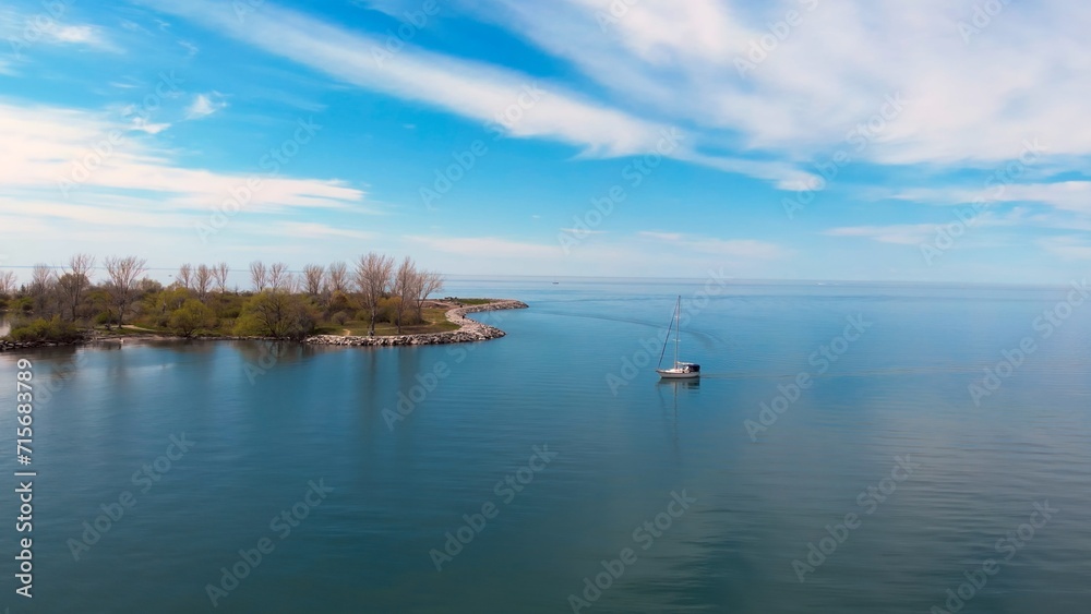 Boat North American lake gently floats near island, epitomizing unusual journey. Serene waters secluded island essence unusual journey, unique escape. unusual journey, stunning beauty. Drone view.