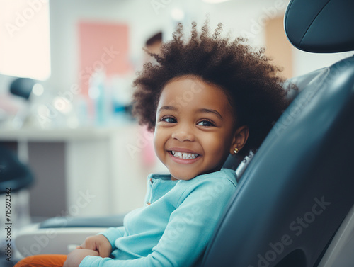 A smiling african american kid sitting in a dental chair at the dentist, teeth cleaning and examination concept, beautiful white teeth smile, young girl