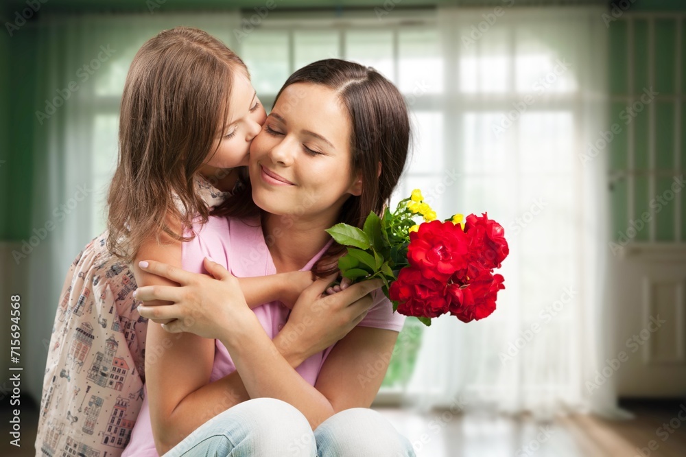 Happy Child congratulates mother and gives bouquet of flowers. Happy Child congratulates mother and gives bouquet of flowers.