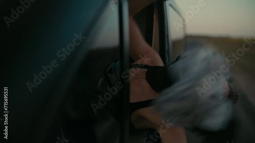 A blond woman burglar riding in a black van And celebrating Successful bank heist photo