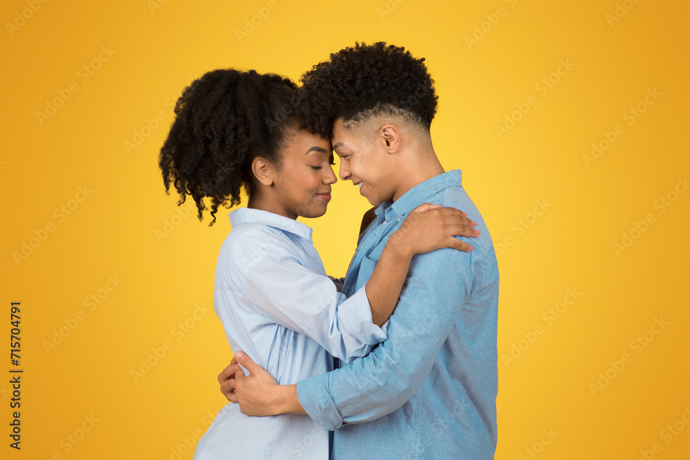 An intimate moment between two young individuals with eyes closed and heads touching An intimate moment between two young individuals with eyes closed and heads touching