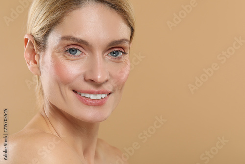 Beautiful woman with healthy skin on beige background  space for text