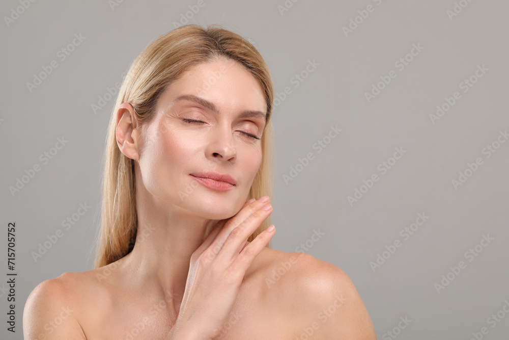Beautiful woman with healthy skin on gray background, space for text Beautiful woman with healthy skin on gray background, space for text