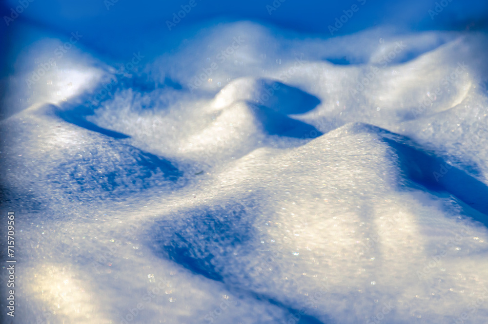 The winter winds have blown the snow into these abstract shapes in our yard in Windsor in Upstate NY.  The shade is blue with the setting sun casting a warm glow and sparkle to the highlights.