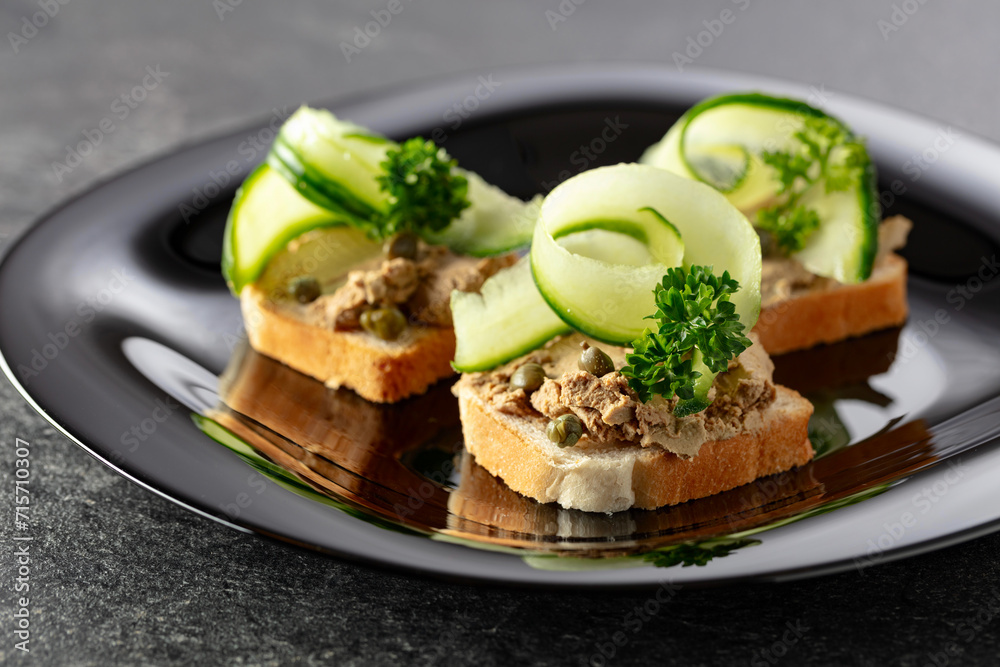 Open sandwiches with pate, fresh cucumber, capers, and parsley. Open sandwiches with pate, fresh cucumber, capers, and parsley.