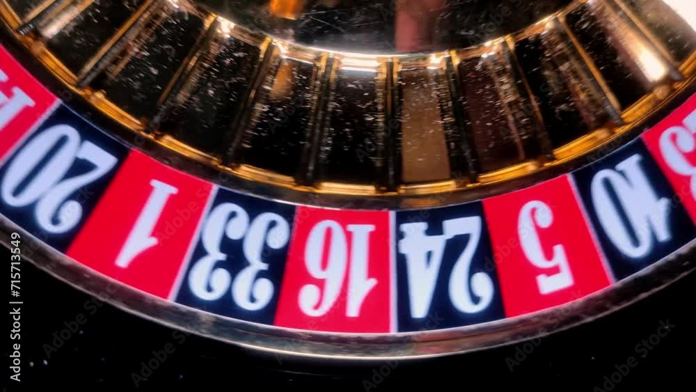 Casino roulette wheel with ball and numbers on a dark background, close-up Casino roulette wheel with ball and numbers on a dark background, close-up