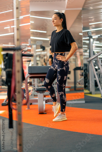 young girl in sportswear in the gym doing leg exercises before training healthy lifestyle