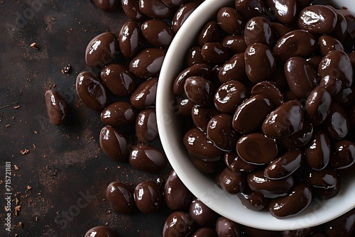 Organic Indulgence, Close-Up view of Dark Brown Chocolate-Covered Raisins in Irregular Forms photo